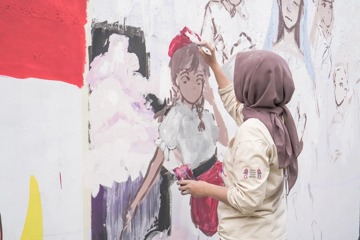 Female muslims young artist is having a competition to draw a mural on the wall with the theme of the 78th Independence Day of the Republic of Indonesia